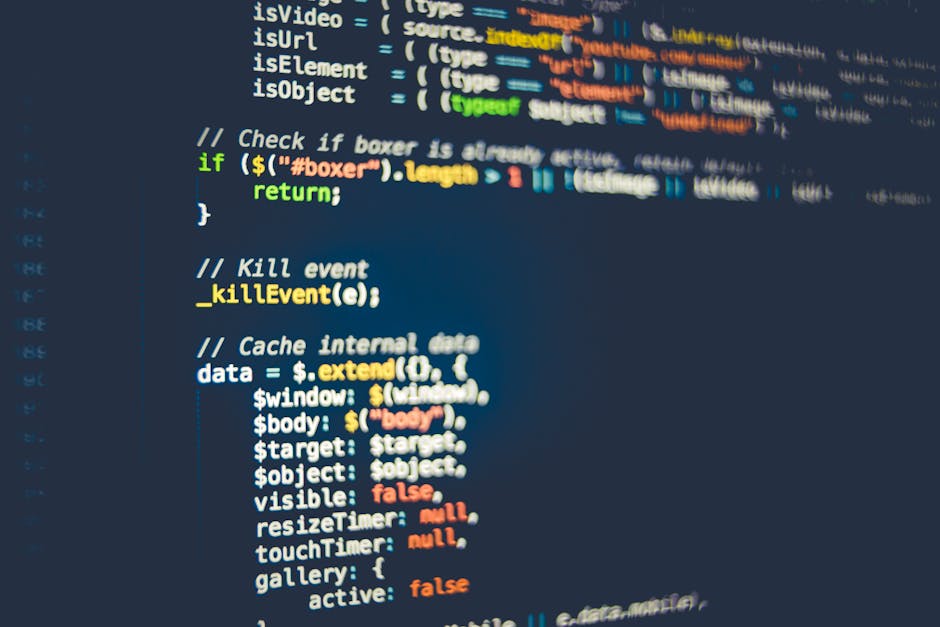 Close-up view of a computer screen displaying lines of colorful programming code in multiple colors such as green, yellow, blue, and orange, with various keywords, functions, and syntactic elements vi